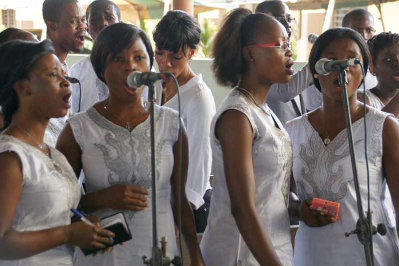 Choir members singing at microphones