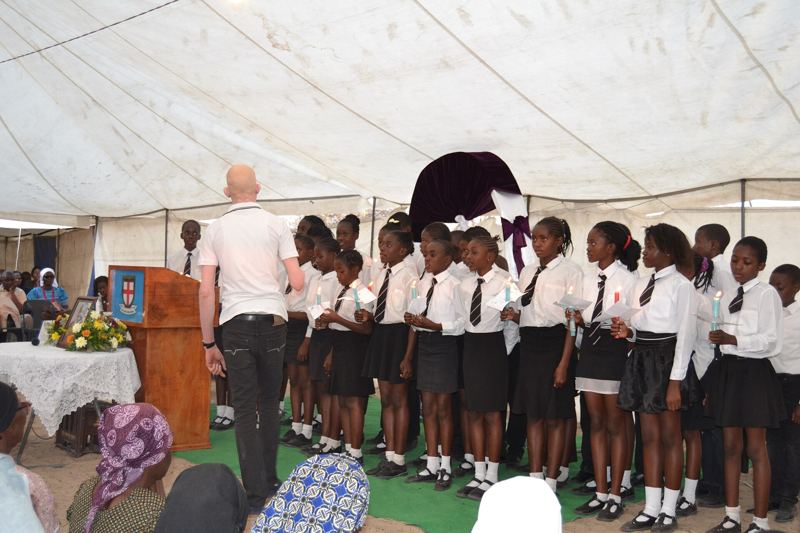 A conductor directs a school choir