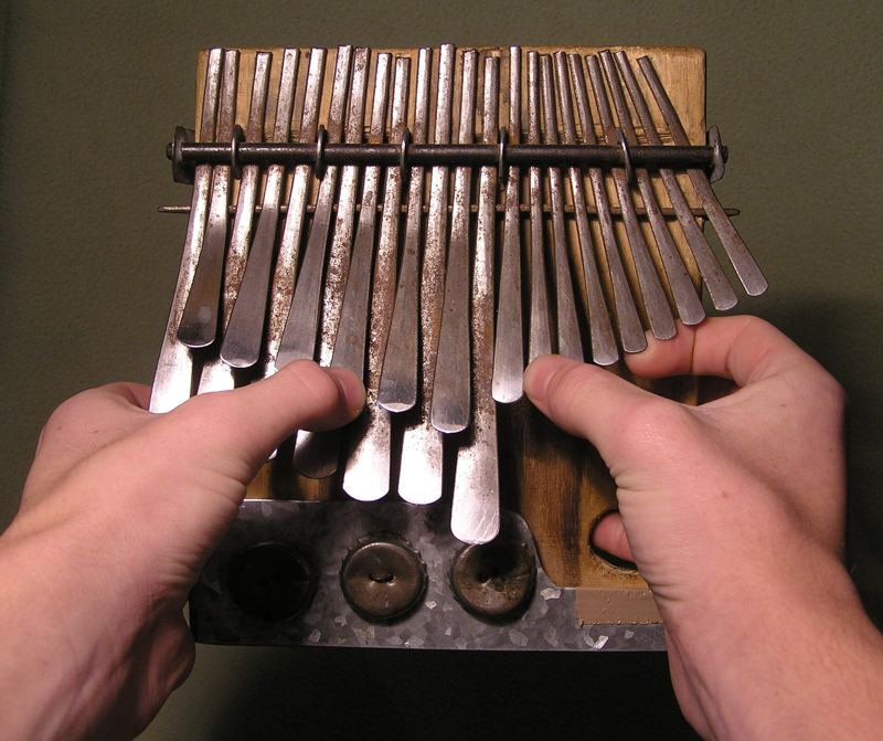 Hands playing an mbira dzavadzimu